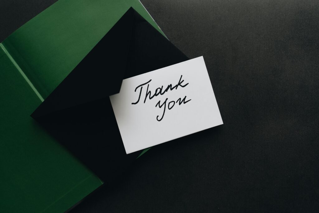 Minimalist thank you card with green envelope, perfect for expressing gratitude.